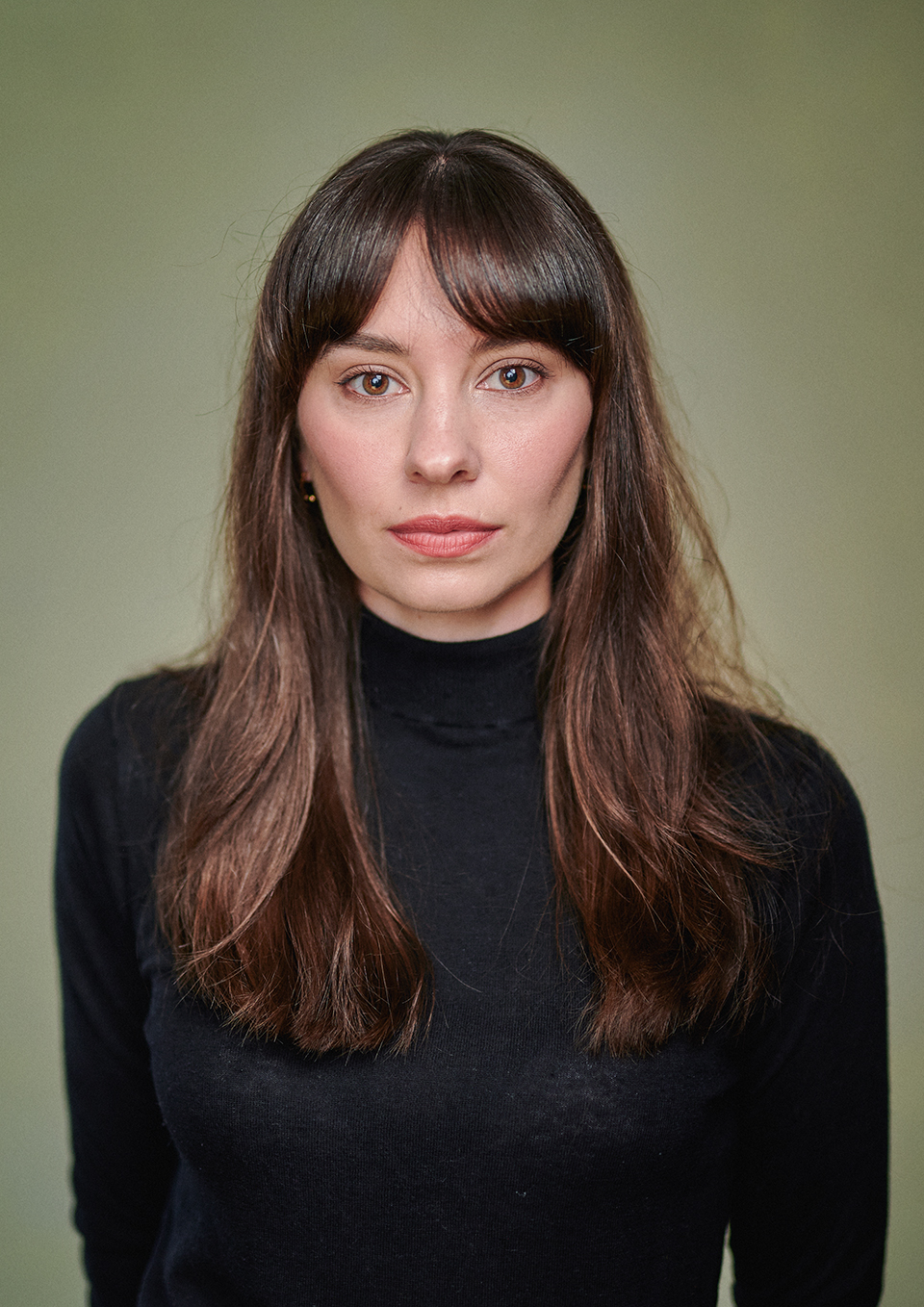 Actor headshot of Agata Frankowska with a hand painted yellow canvas backdrop, London studio