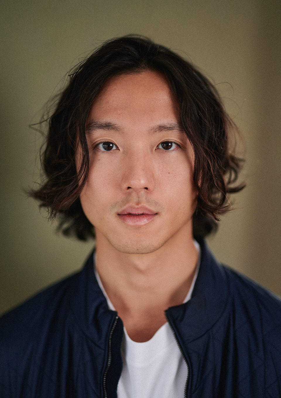 Actor headshot of Charlie in a London studio with an ochre canvas backdrop