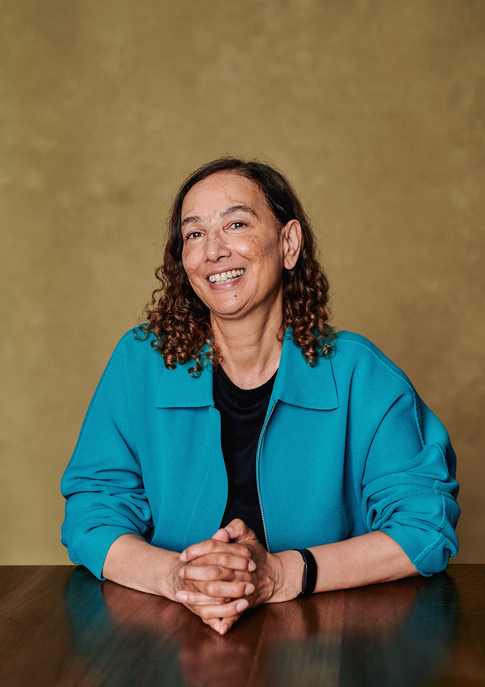 Author portrait of Jacqueline Crooks with a green canvas backdrop, London studio