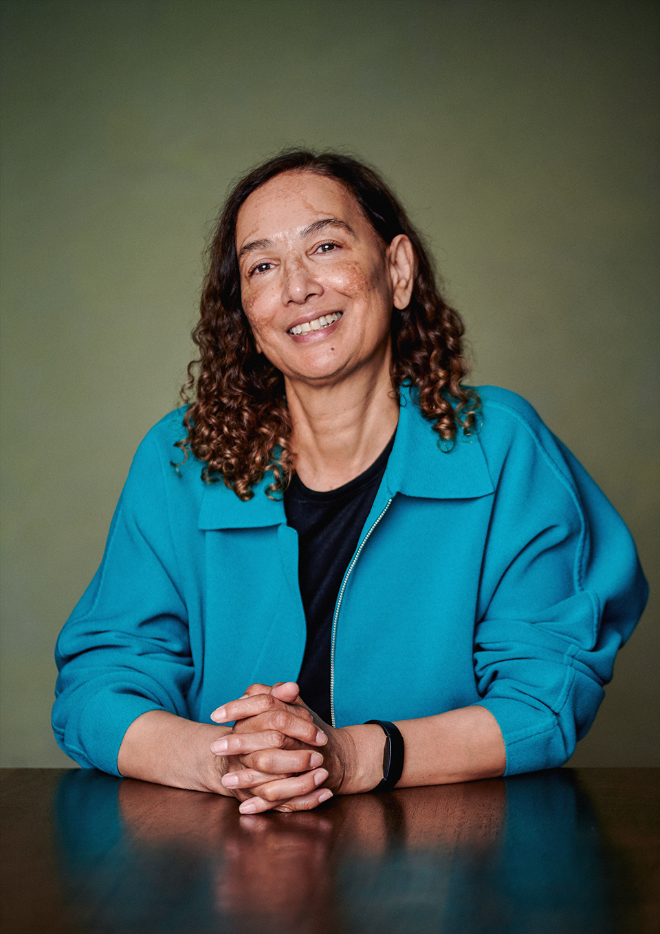 Author portrait of Jacqueline Crooks with an ochre canvas backdrop, London studio