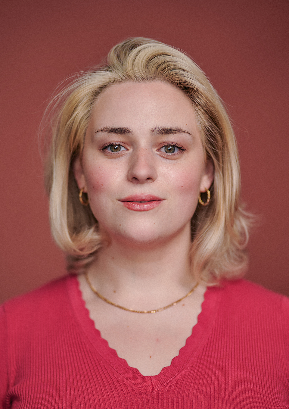 Actor headshot of Mary Timbrell-Hill with a terracotta canvas backdrop, London studio