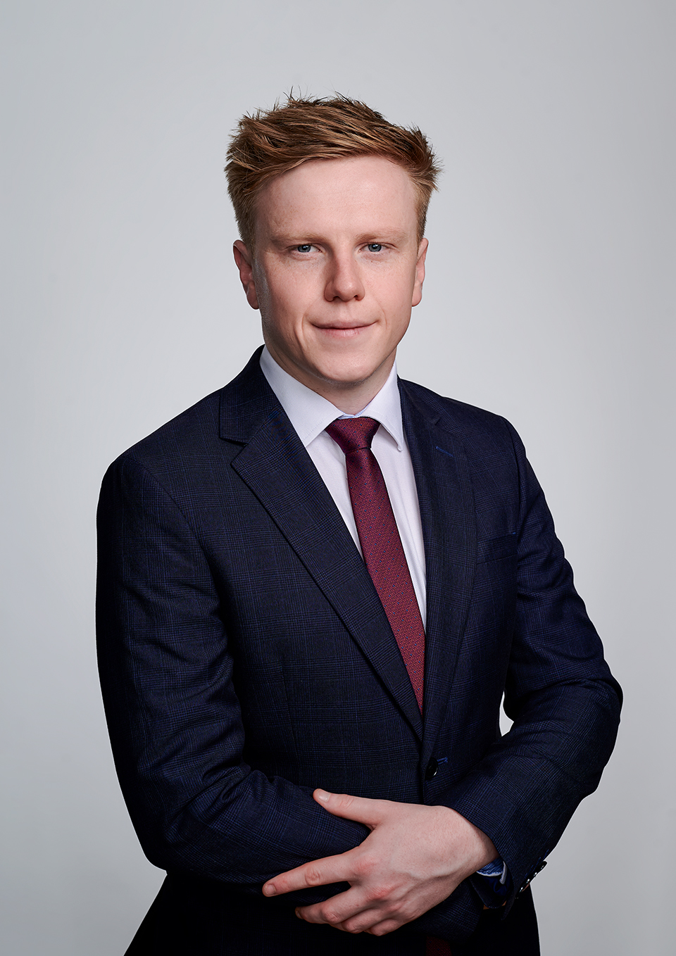 Smart casual LinkedIn headshot of Rhys Joseph, London studio with a white background
