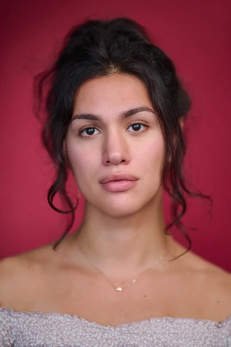 Actor Headshot of Olivia in my London Studio with natural light and a deep red backdrop