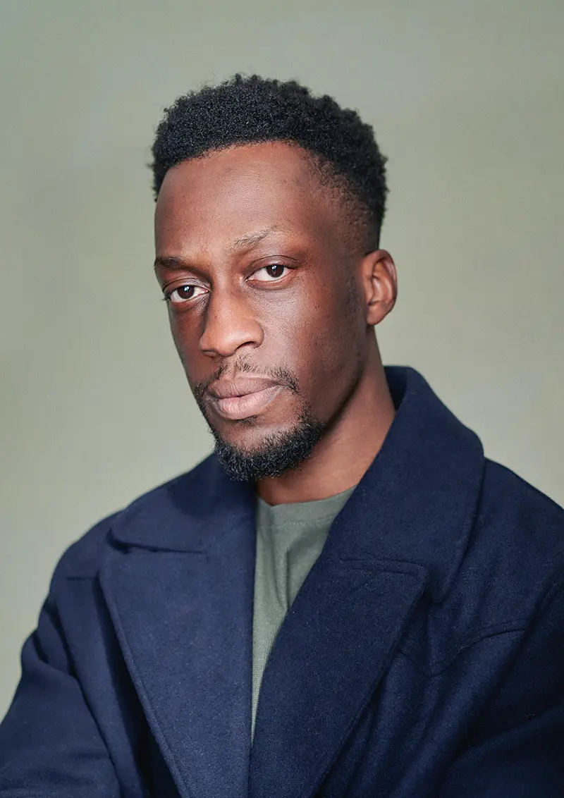 Lanre Danmola's professional actor headshot in London studio with green canvas backdrop
