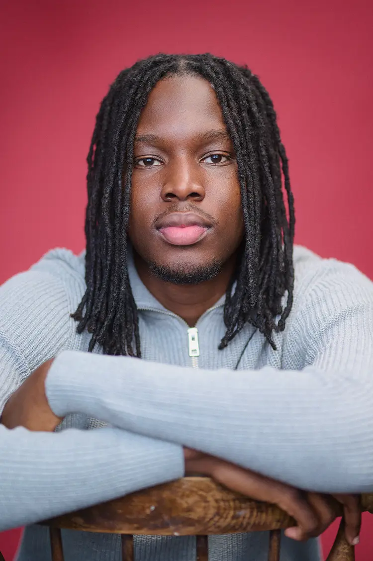 Portrait of actor Ben in my London studio with a theatre red canvas backdrop.