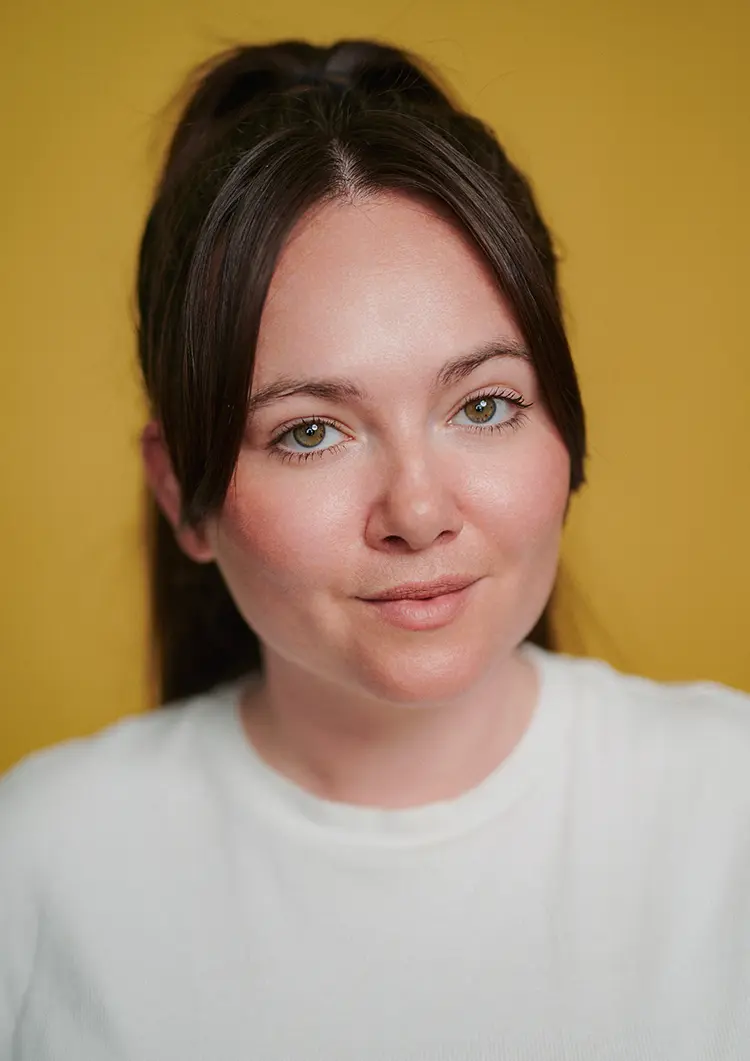 Actor headshot of Ellie in my London studio with a yellow backdrop.