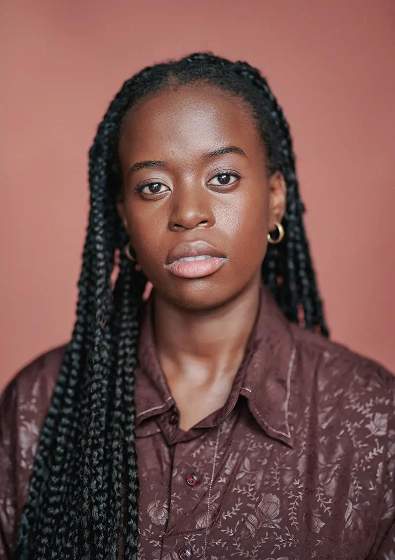 Tommi Otieno Professional Actor Headshot in London Studio with painted canvas backdrop.