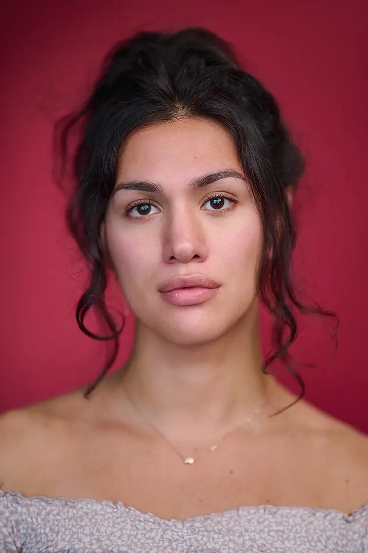 Actor Headshot of Olivia in my London Studio with natural light and a deep red backdrop