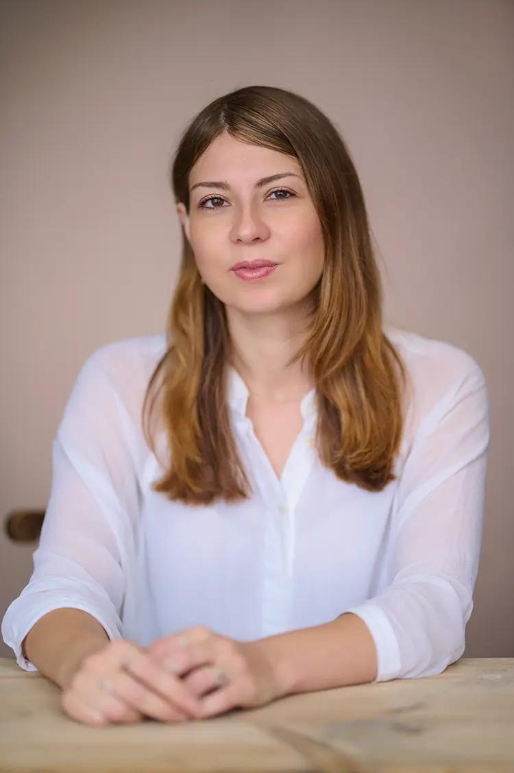 Portrait of author Hetta Howes in my Herne Hill studio, captured with natural light and a pink canvas backdrop.
