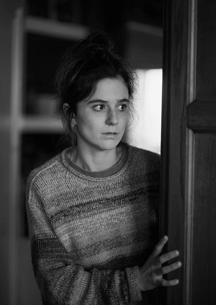 Behind the scenes black and white photo of actress during filming of film