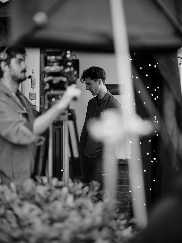 Photo of cameraman and actor during film shoot