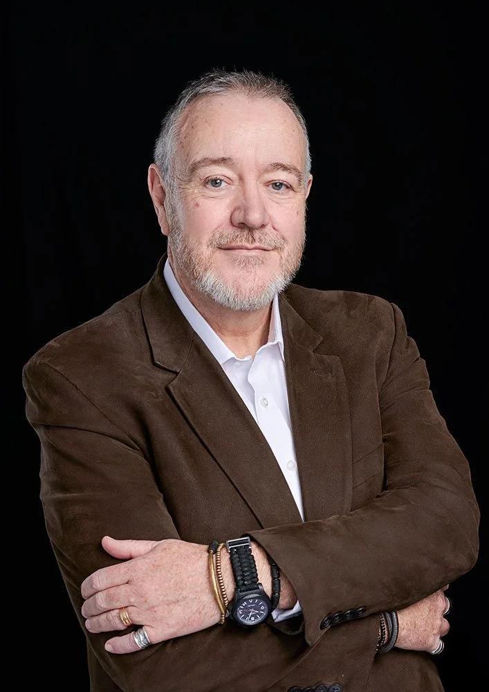 Corporate headshot portrait London with clean, modern lighting and dark background