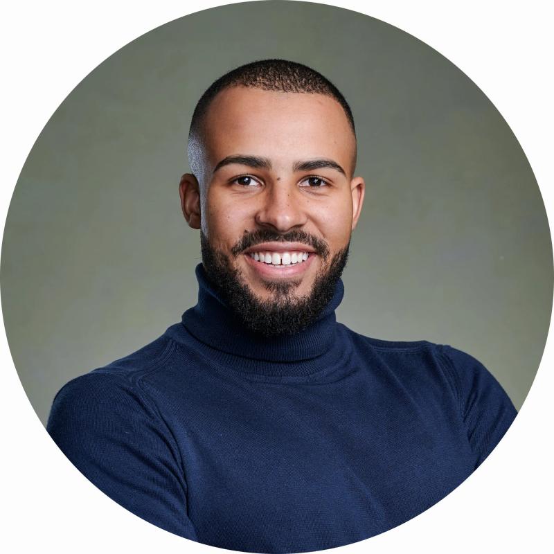 LinkedIn headshot of Tas in my studio with professional lighting and a green canvas backdrop