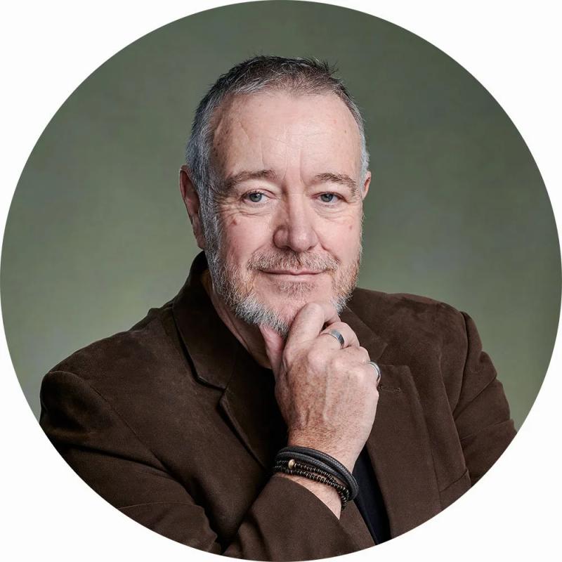 Professional business portrait of psychologist John in my London studio, featuring a green canvas backdrop, ideal for use on LinkedIn.
