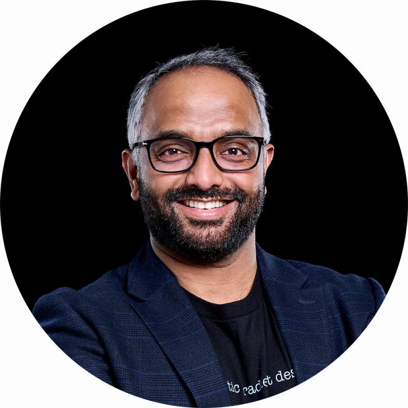 Anup Professional LinkedIn Headshot with black background.