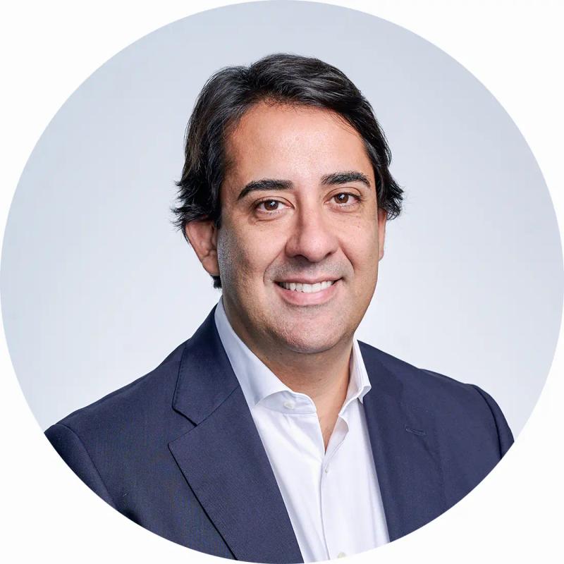 Business headshot of Andrea in-studio with professional lighting and a white backdrop.