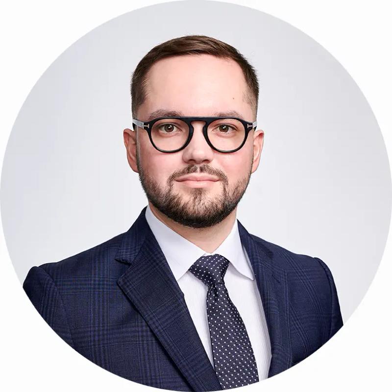 Professional headshot of London businessman in studio with classic white backdrop.