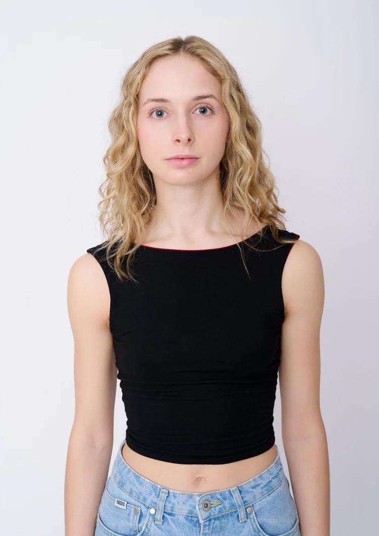 Female model digitals London full length jeans and black top front view