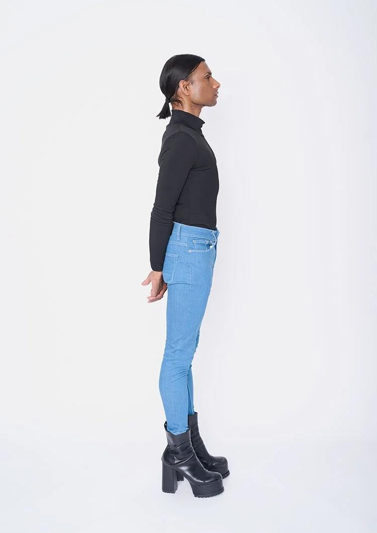 Male model polaroids London full length side view skinny jeans and black top