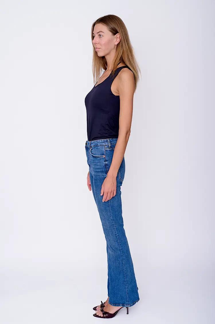 Professional side profile model digital in London studio with clean white backdrop.